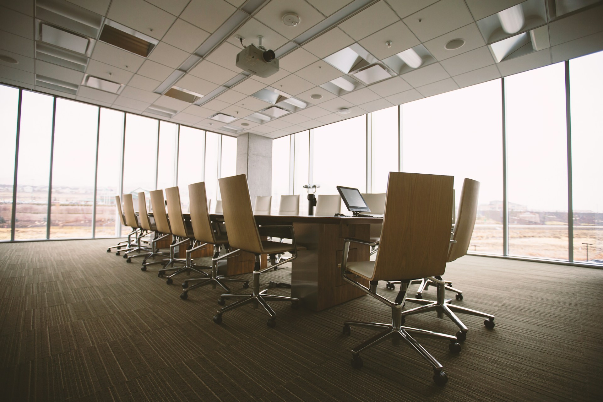 Executive boardroom with long conference table and floor-to-ceiling windows