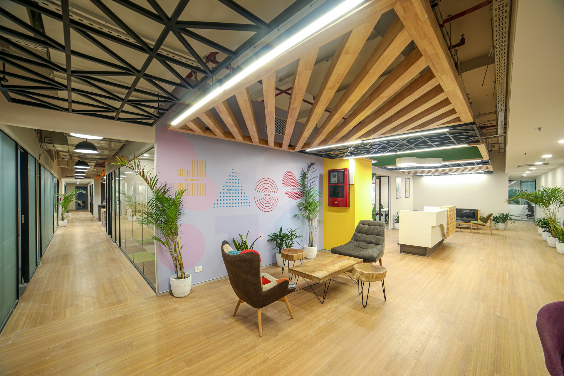 Co-working lounge with exposed beams and collaborative seating