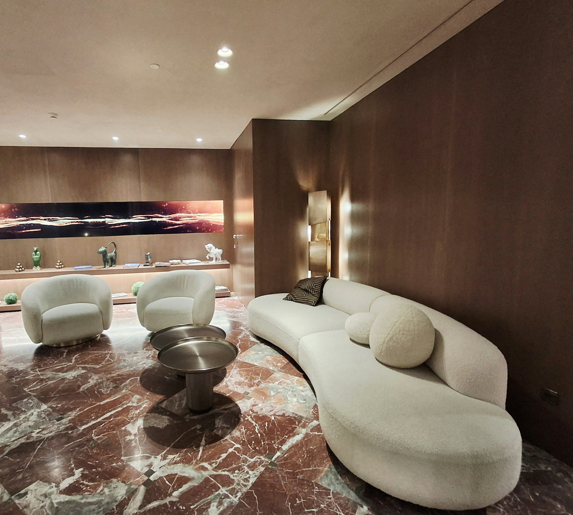 Grand luxury lounge with curved sofa and marble floor
